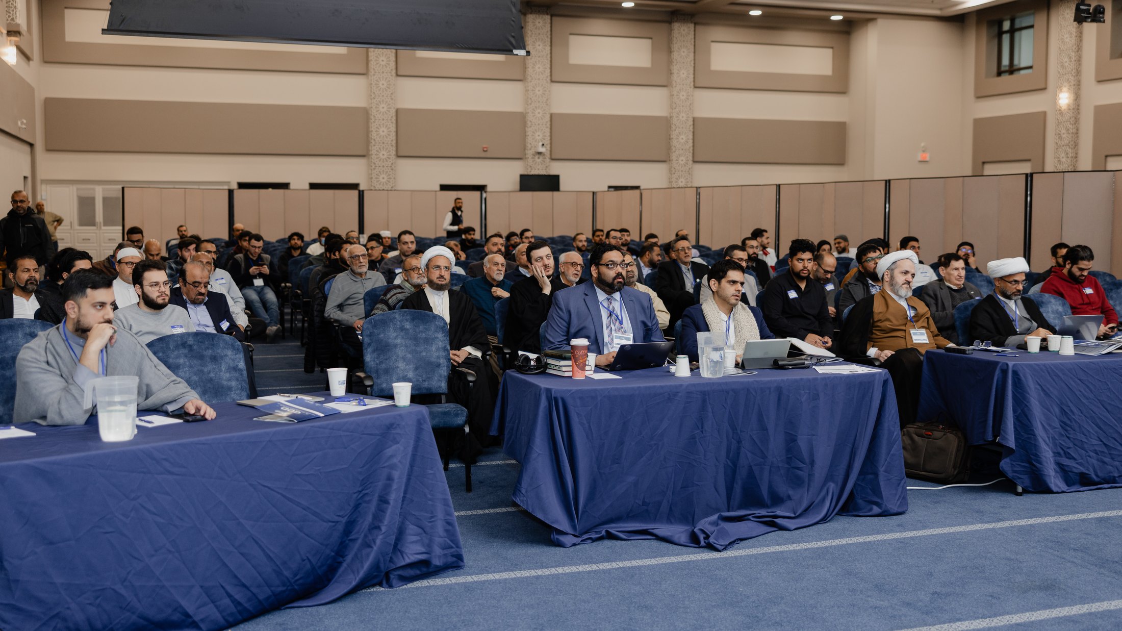 Delegates seated at an ICAIR conference, following a presentation.